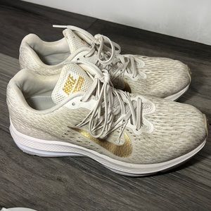 White and gold Nike shoes